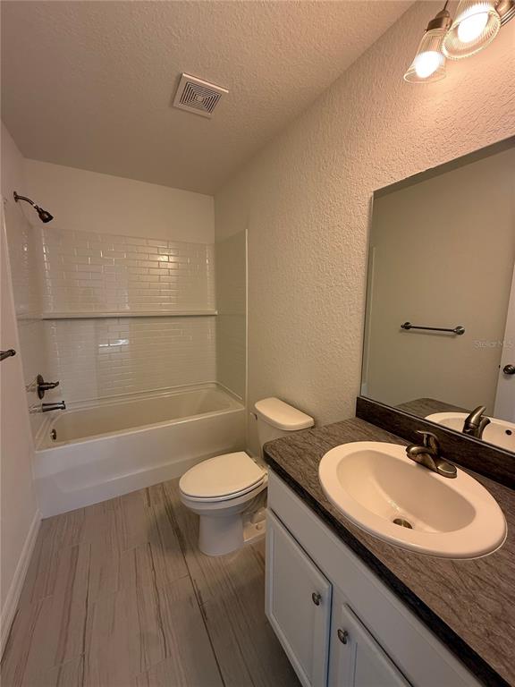 24449 Falcon Avenue Dunnellon, FL 34431 - Photo 9 of 11 a bathroom with a sink a toilet a mirror and bathtub