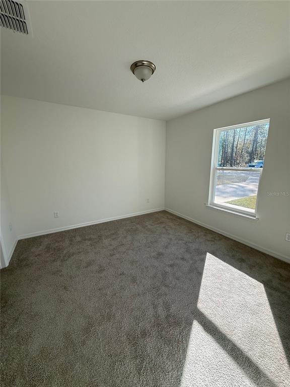 24449 Falcon Avenue Dunnellon, FL 34431 - Photo 10 of 11 an empty room with windows