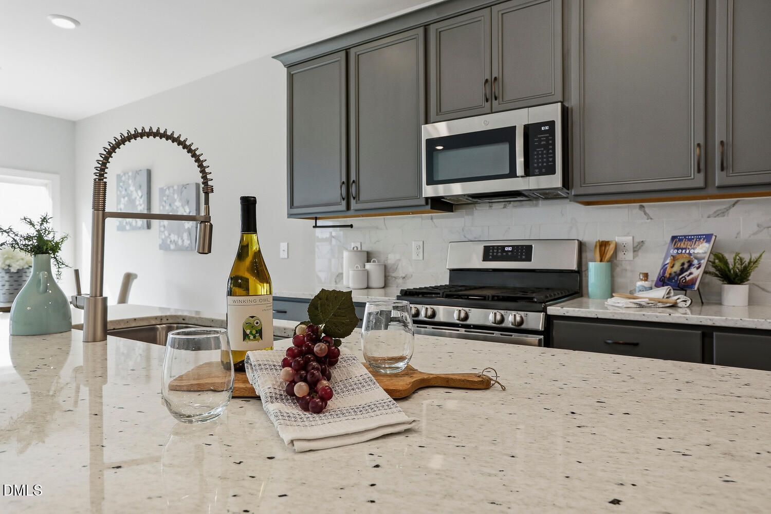 a kitchen with stainless steel appliances granite countertop a stove and a microwave with cabinets