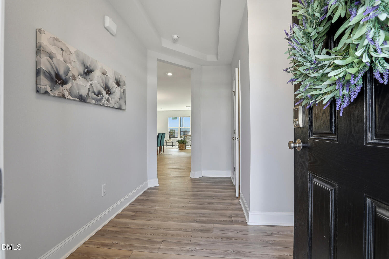 1035 Heartstone Way Durham, NC 27713 - Photo 4 of 37 a view of a hallway with wooden floor and a potted plant