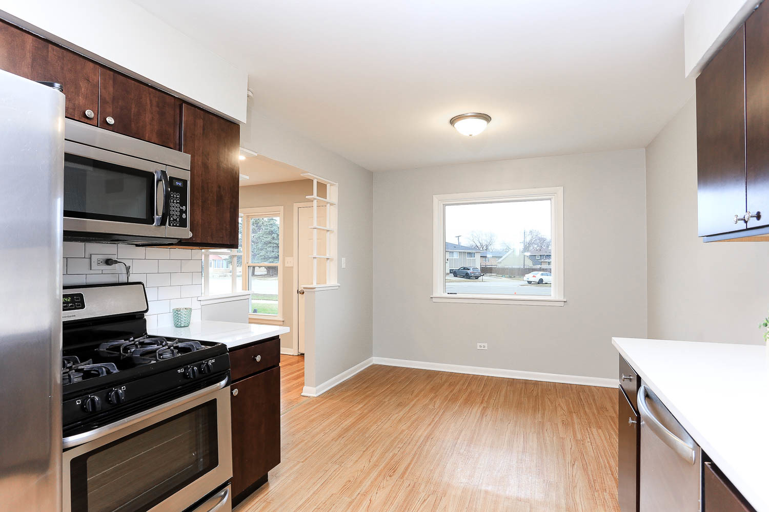 7736 State Road Burbank, IL 60459 - Photo 11 of 20 a kitchen with a stove and a microwave