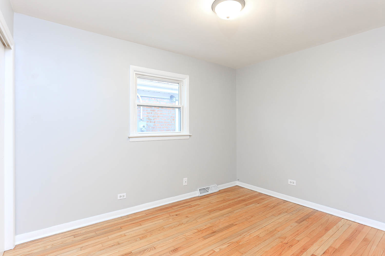 7736 State Road Burbank, IL 60459 - Photo 14 of 20 a view of an empty room with wooden floor and a window