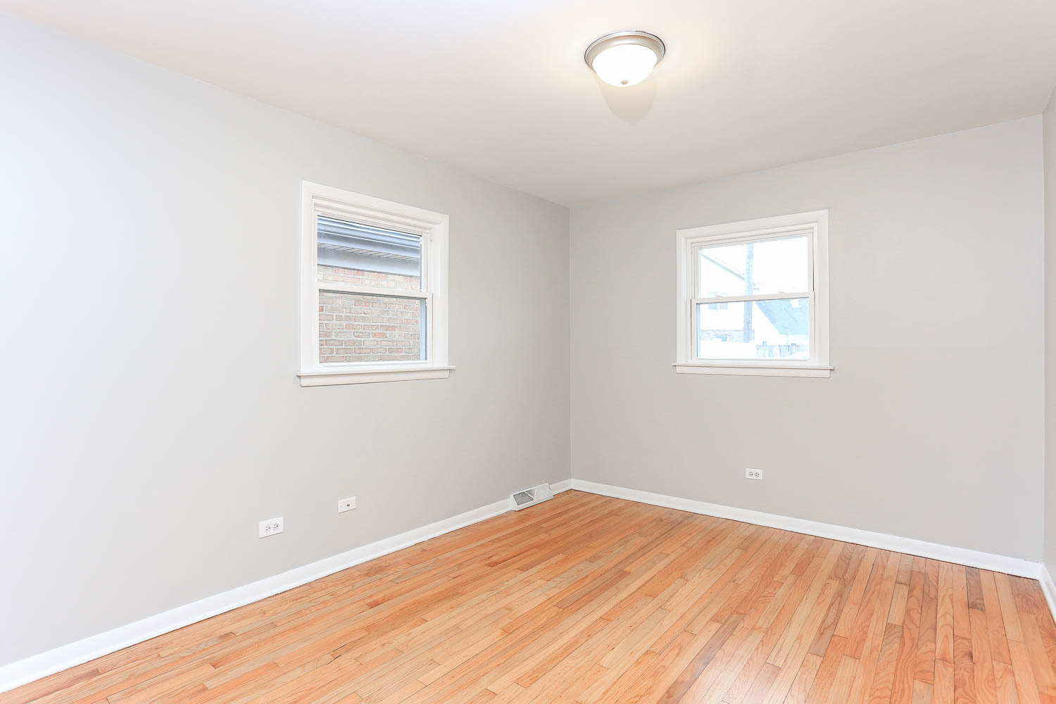 7736 State Road Burbank, IL 60459 - Photo 16 of 20 an empty room with wooden floor and windows
