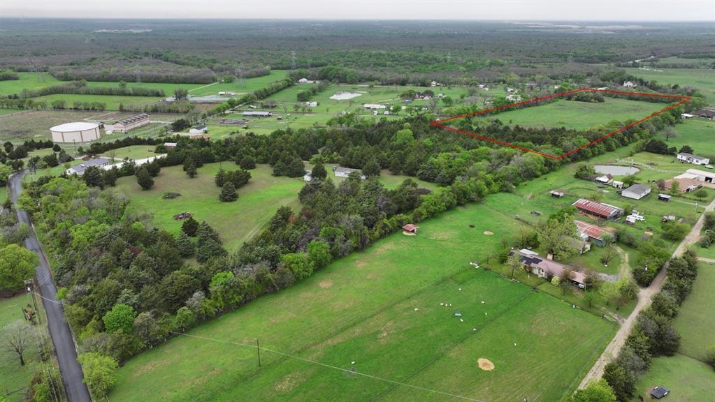 an aerial view of green landscape with trees all around