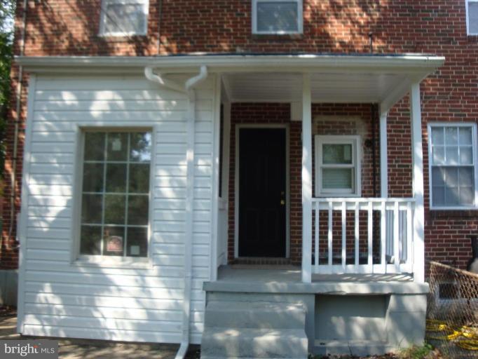 5749 Maplehill Road Baltimore, MD 21239 - Photo 6 of 15 front view of a brick house with large windows