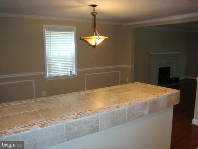 5749 Maplehill Road Baltimore, MD 21239 - Photo 7 of 15 a bedroom with a bed and a chandelier