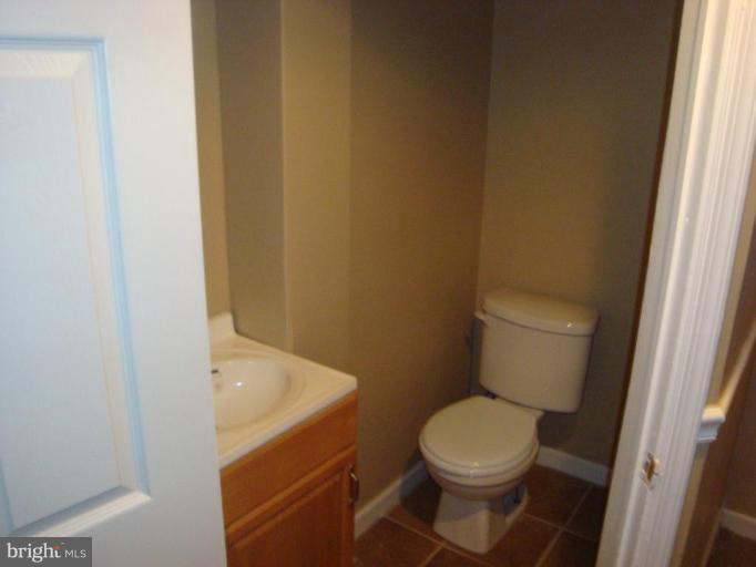 5749 Maplehill Road Baltimore, MD 21239 - Photo 10 of 15 a white toilet sitting next to a small sink