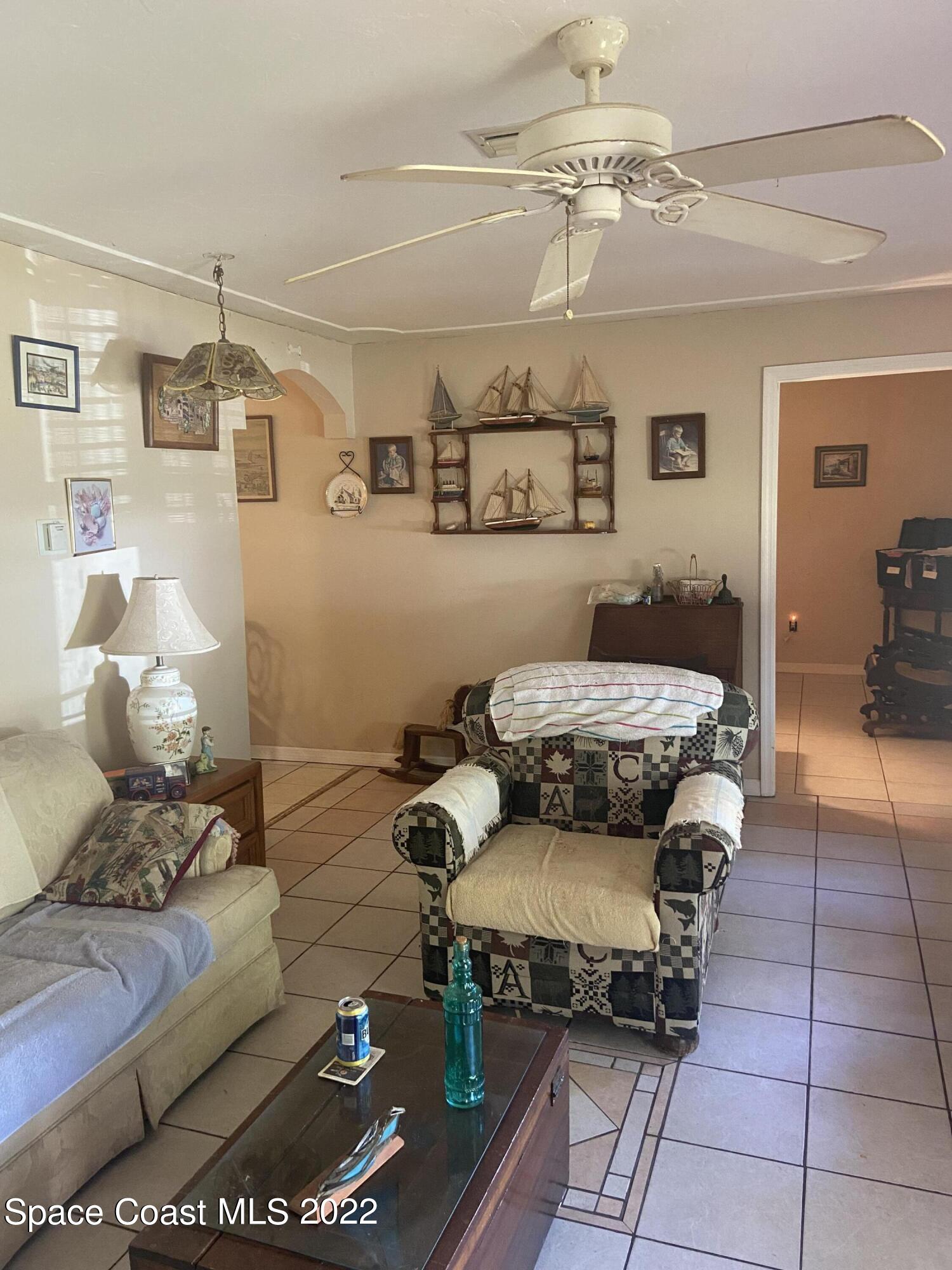435 East Crisafulli Road Merritt Island, FL 32953 - Photo 2 of 6 a living room with furniture and a chandelier