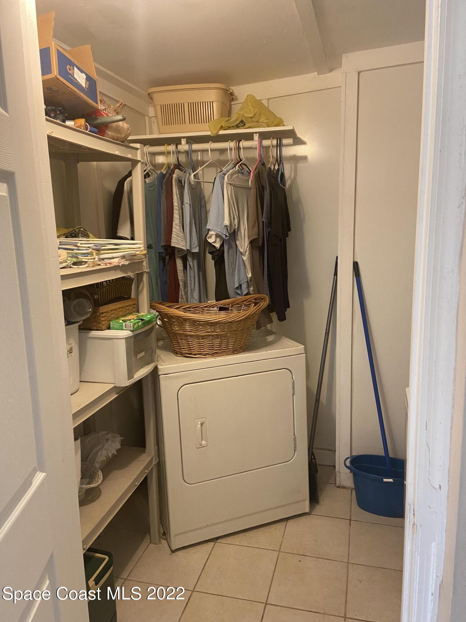 435 East Crisafulli Road Merritt Island, FL 32953 - Photo 4 of 6 a view of walk in closet with clothes and shoes
