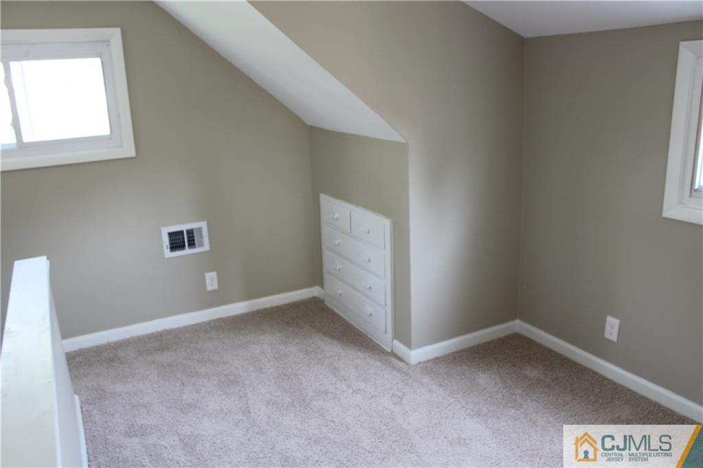 23 Roberts Road New Brunswick, NJ 08901 - Photo 22 of 22 an empty room with windows
