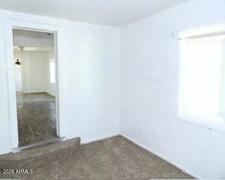 a bathroom with a granite countertop sink a mirror and shower