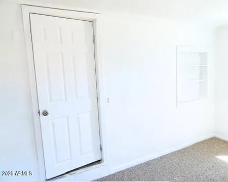 a view of a small space with wooden floor and a window