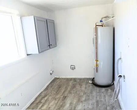 a view of a small space with wooden floor and a window