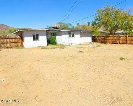 a front view of a house with a yard and mountain view