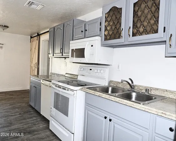 a kitchen with cabinets a sink and stainless steel appliances