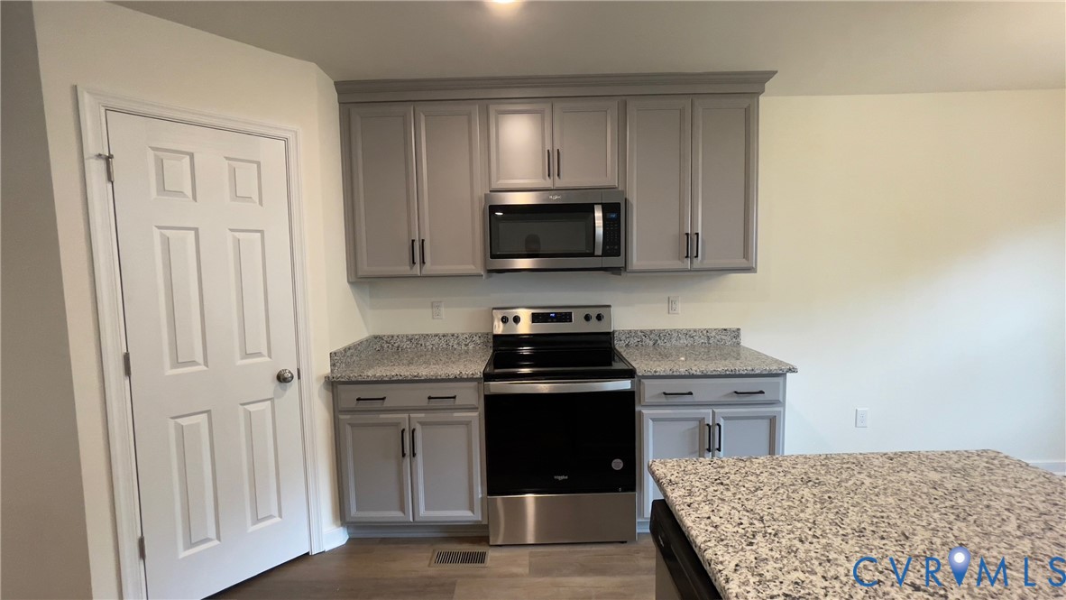 4944 Bailey Woods Lane Midlothian, VA 23112 - Photo 21 of 50 a kitchen with a stove and a microwave
