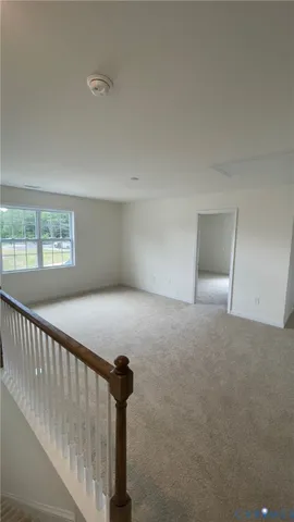 a view of empty room with windows and closet