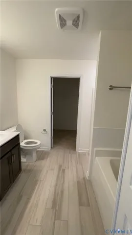 a white bath tub sitting next to a shower