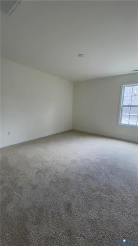 a view of an empty room and a window