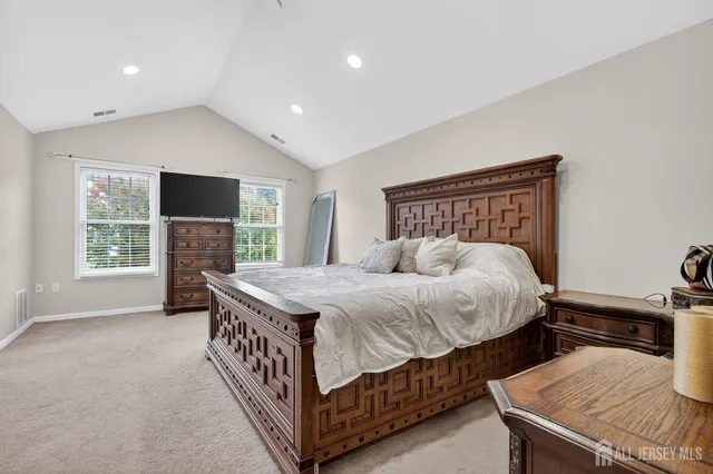 a bed sitting in a bedroom next to a window