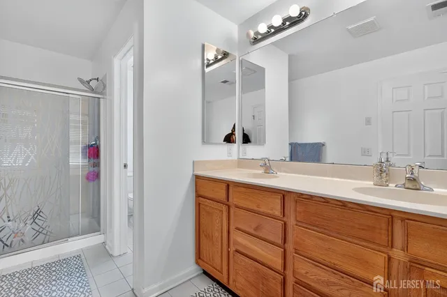 a bathroom with a double vanity sink and mirror