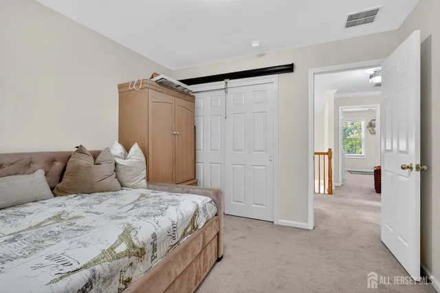 a bedroom with a large bed and a chandelier