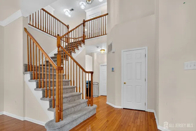a view of entryway with wooden floor and stairs