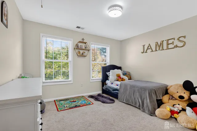 a kids bedroom with a bed and a window