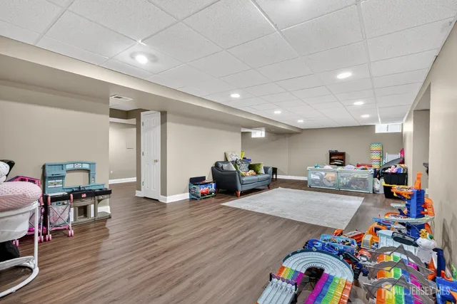 a view of a room with wooden floor and furniture