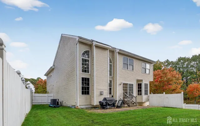 a front view of a house with a yard and trees