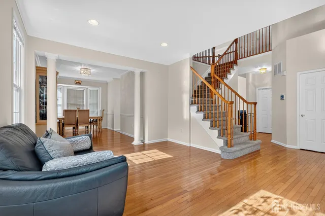 a living room with furniture and wooden floor