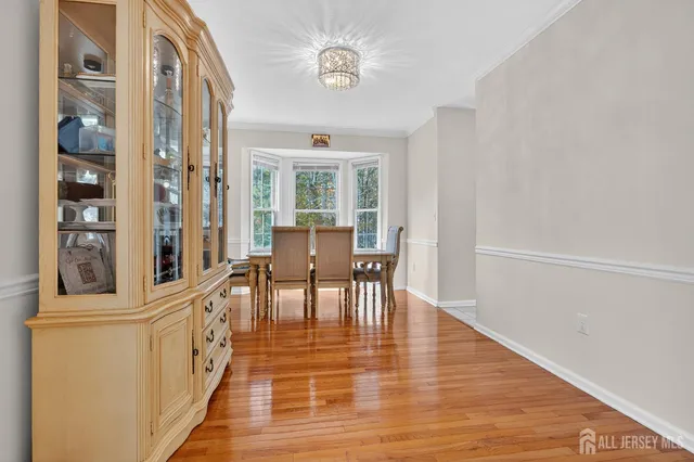 a view of a dining room with furniture a chandelier and wooden floor