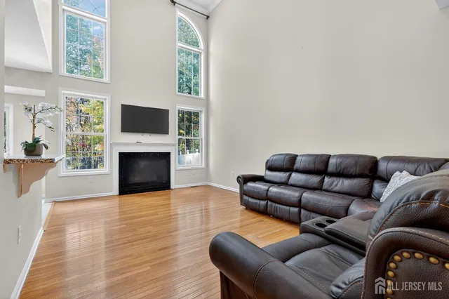 a living room with furniture a flat screen tv and a fireplace
