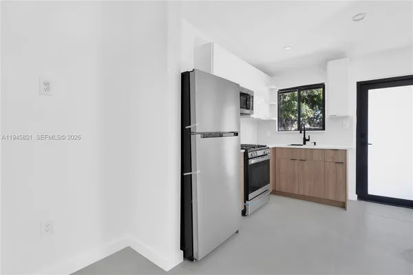 a kitchen with a sink cabinets and stainless steel appliances