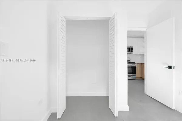 a view of walk in closet with white walls