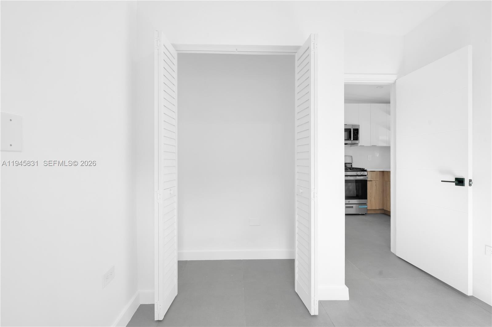 3040 Northwest 93rd Street, Unit D Miami, FL 33147 - Photo 5 of 8 a view of walk in closet with white walls