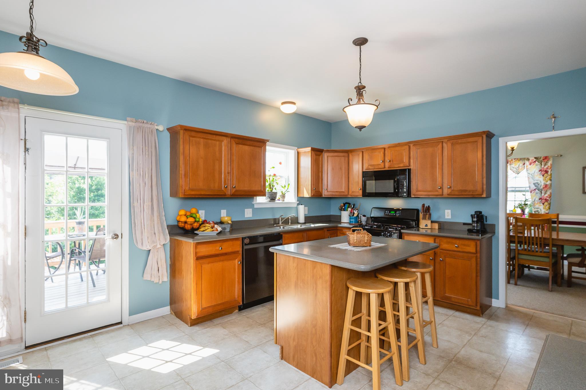 24 Eagleton Drive York, PA 17407 - Photo 20 of 70 a kitchen with stainless steel appliances granite countertop a stove top oven a sink dishwasher a dining table and chairs with wooden floor