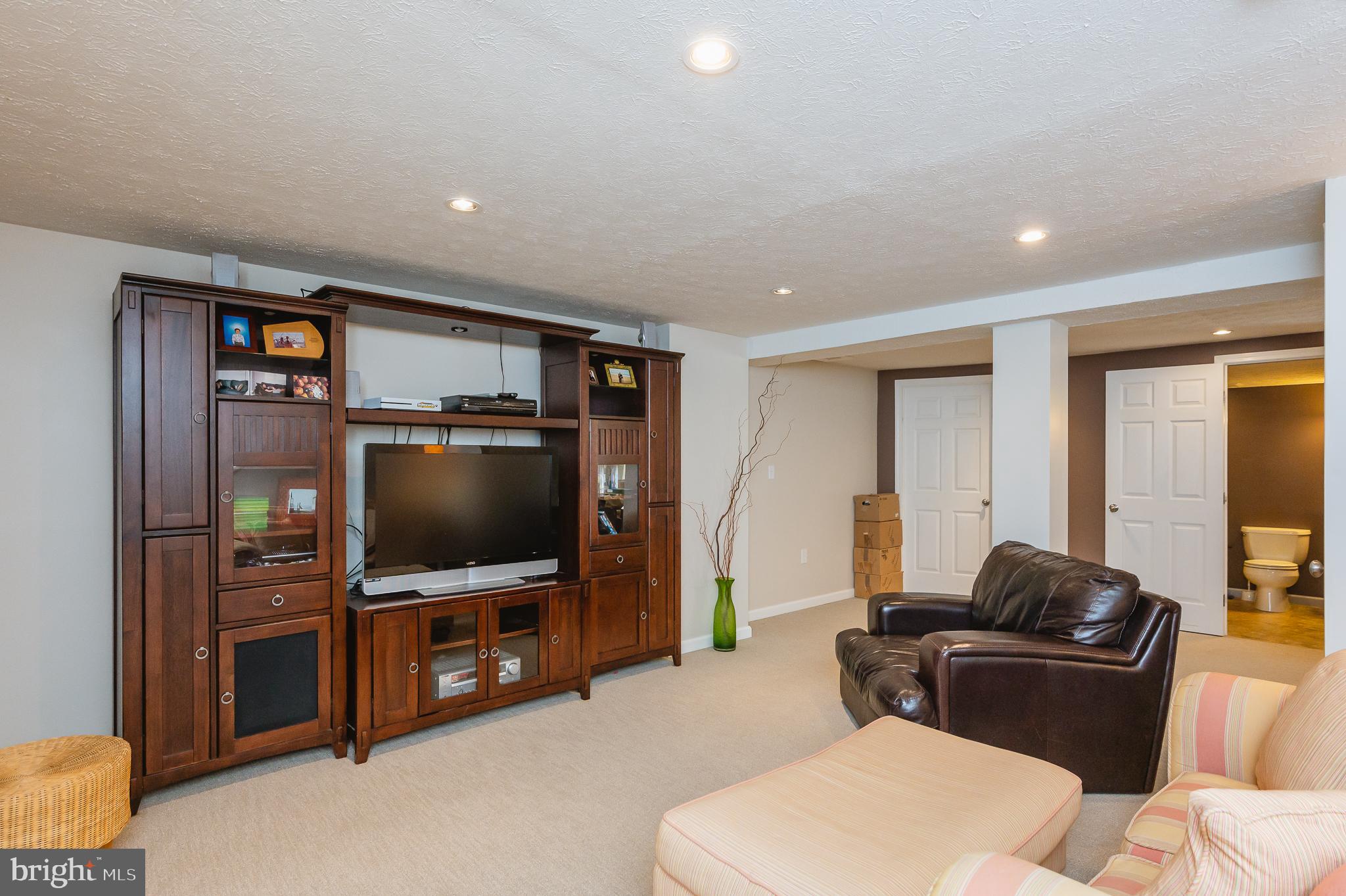 24 Eagleton Drive York, PA 17407 - Photo 49 of 70 a living room with furniture and a flat screen tv
