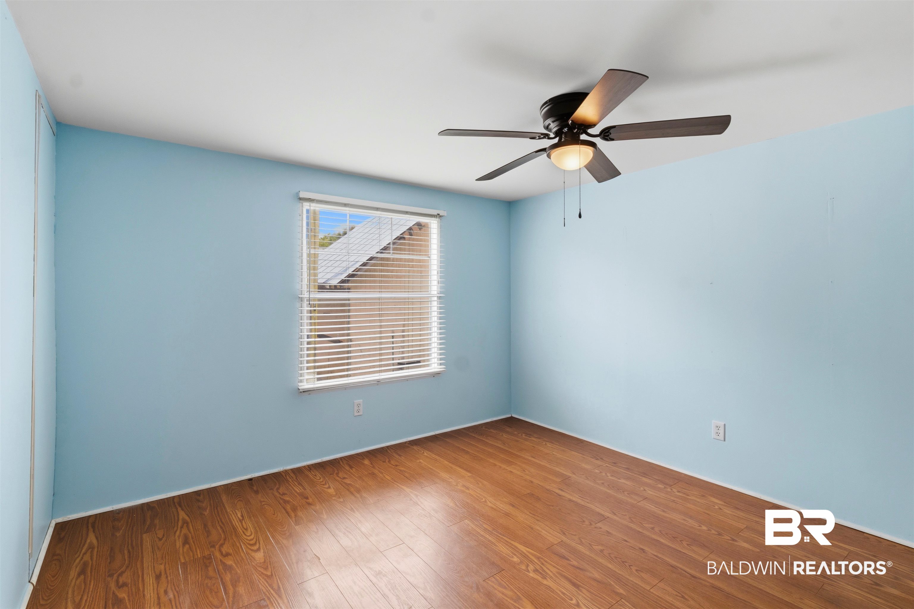 26788 Feely Road Elberta, AL 36530 - Photo 14 of 31 Room featuring wood-finish flooring, light blue walls, and a white ceiling