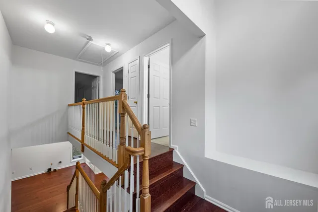 an empty room with wooden floor and fireplace