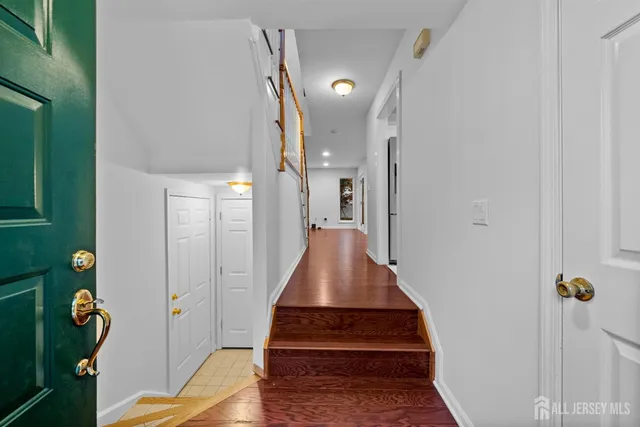 a view of entryway and hall with wooden floor