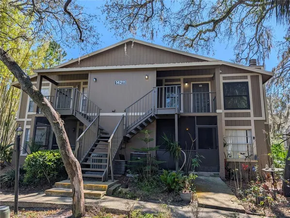 a front view of a house with plants