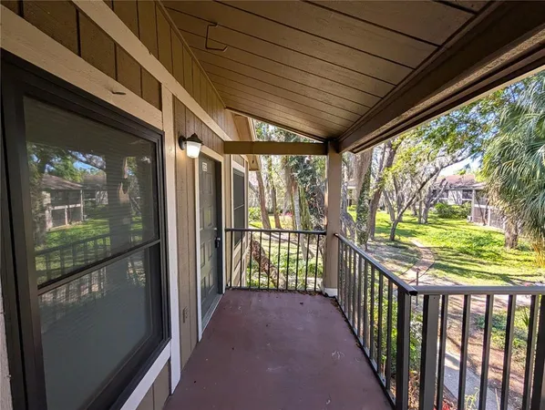 an empty room with windows and fireplace