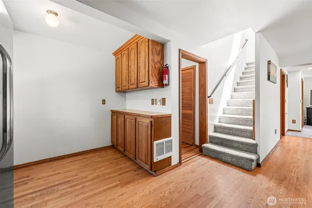a view of a hallway with staircase and white walls