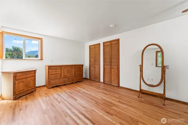 a view of a livingroom with wooden floor and a window