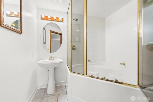 a bathroom with a sink a mirror and shower