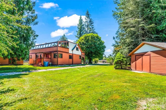 a front view of house with yard and trees