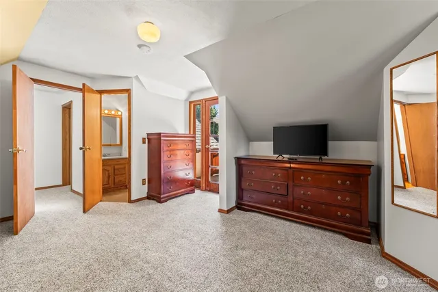 a view of an empty room with window and cabinet