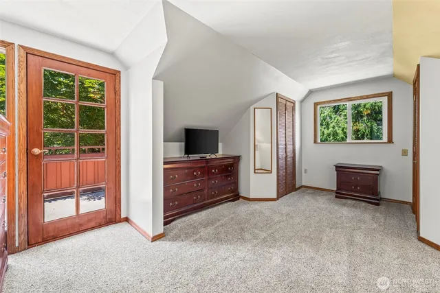 an empty room with windows and closet