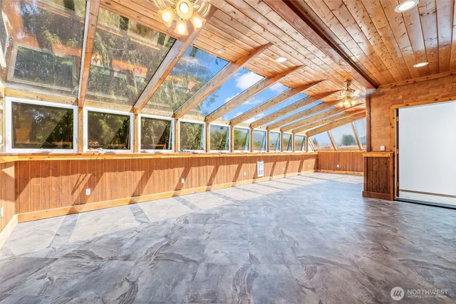 a bathroom with a granite countertop toilet sink and mirror